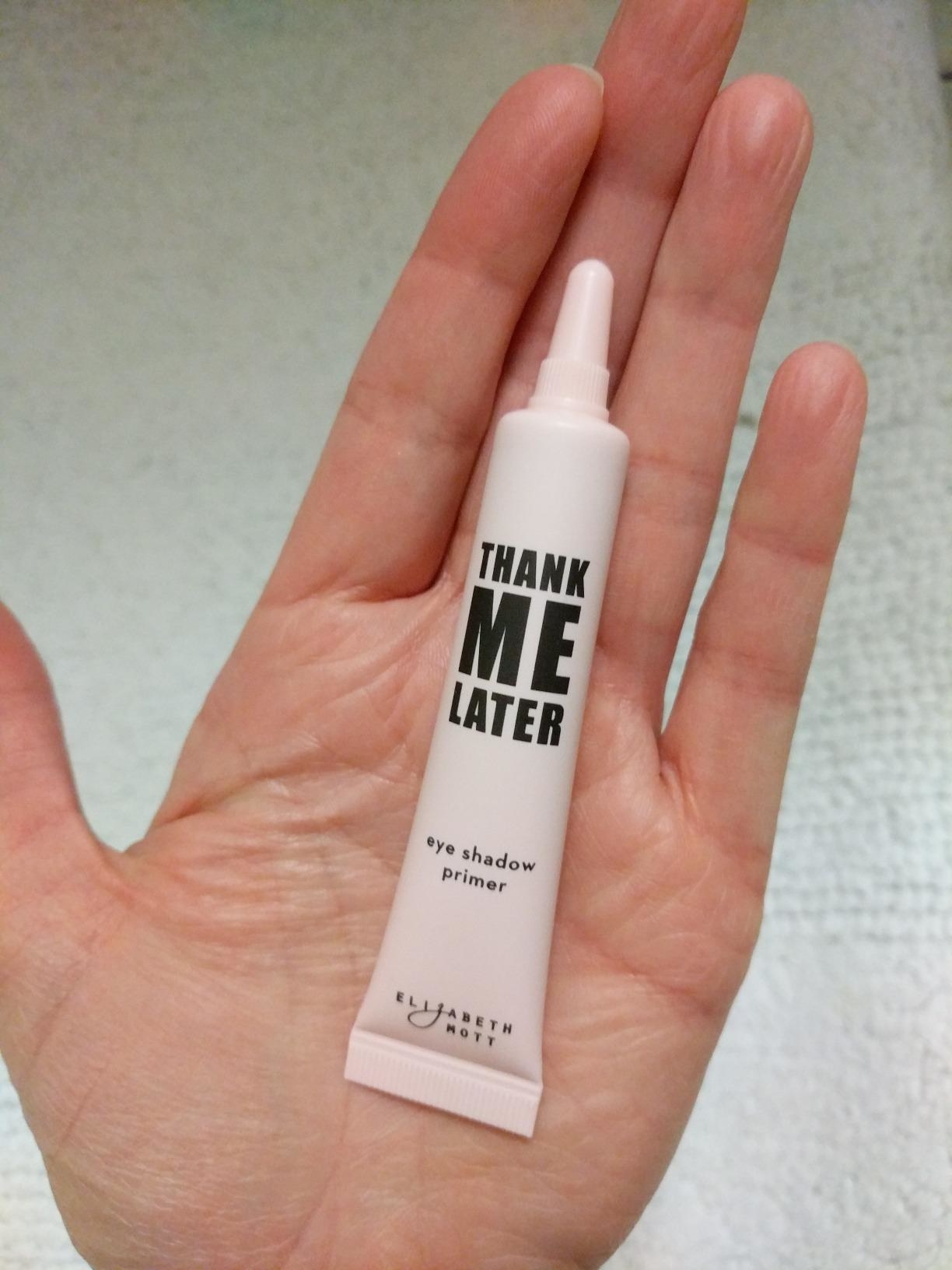 reviewer holding product tube