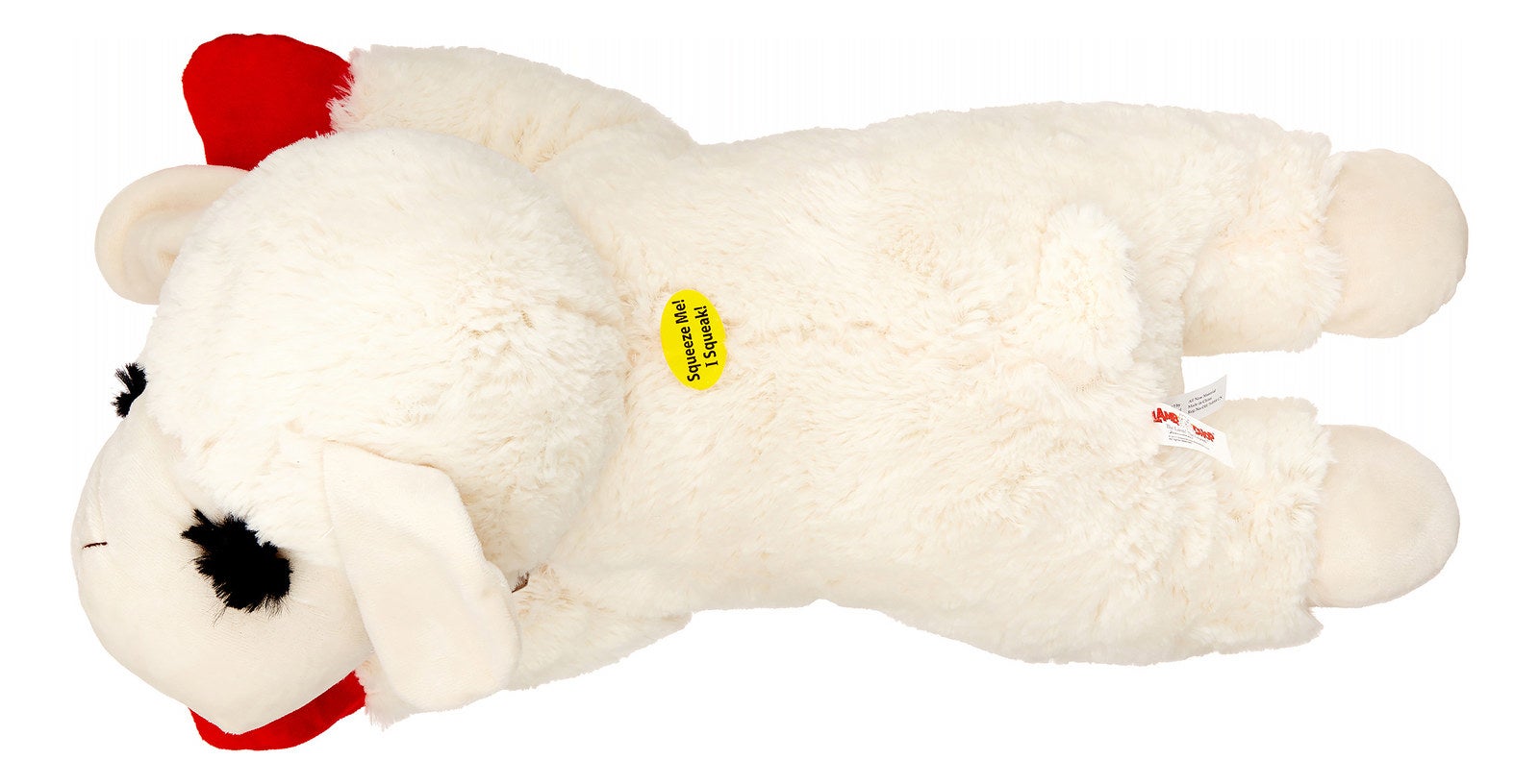 Plush lamb toy lying on its side with a red bow, for sale
