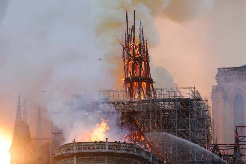 Smoke and flames rise during a fire at the landmark Notre-Dame Cathedral in central Paris on April 15, 2019.