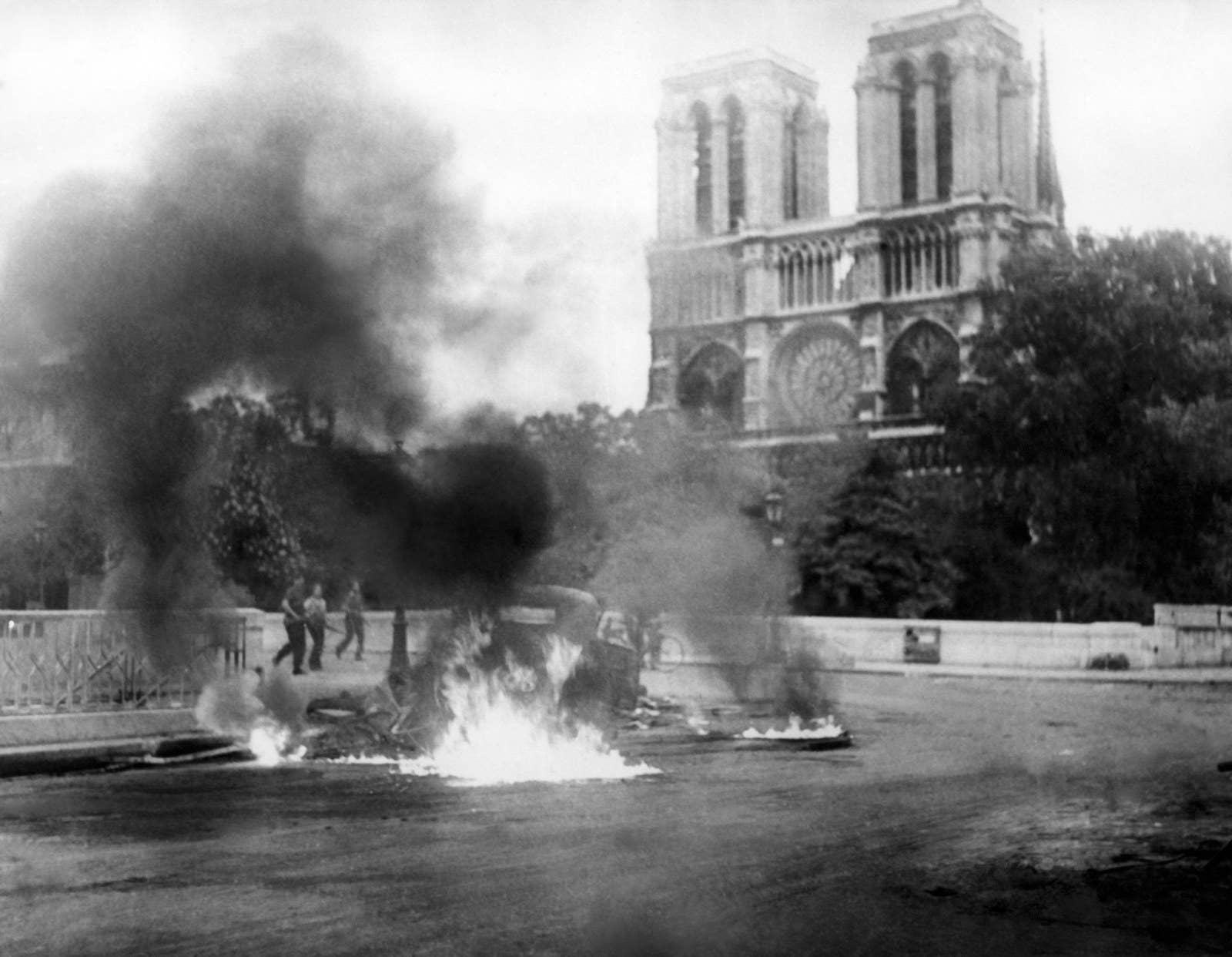 A photo taken circa Aug. 23, 1944 during World War II shows a flaming vehicle close to the Pont Saint-Michel and Notre Dame Cathedral Notre-Dame as part of the "Battle of Paris" opposing the French Forces of the Interior and remaining Nazi forces, a few days before the Liberation of Paris on Aug. 25, 1944.