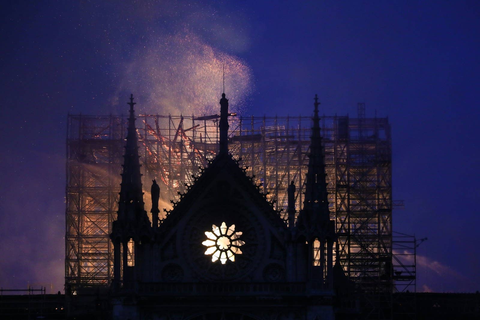 Smoke and flames rise during a fire at the landmark Notre-Dame Cathedral on the evening of April 15, 2019.