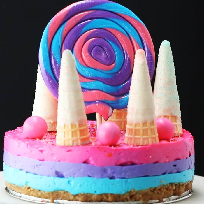 Servings: 8-12 INGREDIENTSCrust20 graham crackers4 tablespoons unsalted butter, melted⅓ cup sugar Filling48 ounces cream cheese1 cup sugar2 tablespoons vanilla extract2 cups warm milk2 tablespoons gelatinPink food coloringPurple food coloringBlue food coloring Unicorn HornsPink sprinklesBlue sprinkles9 mini waffle cones 2 cups white chocolate, melted GarnishSprinklesGumballsSwirl lollipop PREPARATION1. Add the graham crackers to a sealed plastic bag, and use a rolling pie to crush until the graham crackers resemble a fine crumb. Transfer the graham crackers to a bowl, and add the butter and sugar. Mix until thoroughly combined.2. Press the graham cracker crust into a greased 8-inch springform pan and chill.3. Use a handheld mixer to combine the cream cheese, sugar, and vanilla extract.4. Microwave the milk for two minutes, and mix with the gelatin. Add the gelatin and milk to the cream cheese mixture. 5. Separate the batter into three separate bowls. Add a drop of food coloring to each bowl, and stir to combine. 6. Layer the blue batter into the graham cracker crust and refrigerate for 30 minutes, or until firm. Repeat with the purple batter, and refrigerate for 30 minutes. Repeat with the pink batter, and refrigerate for 60 minutes.7. Dip each waffle cone into the white chocolate, top with sprinkles, and chill until firm.Top the cheesecake with the sprinkles, unicorn horns, gumballs, and the lollipop. 8. Enjoy! Appearance Inspiration: https://www.instagram.com/p/BT54zuyB_kC/?taken-by=katherine_sabbath&hl=en Recipe Inspiration: https://www.facebook.com/buzzfeedtasty/videos/1890540204531953/