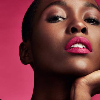 Model wearing the lip paint in a bold pink