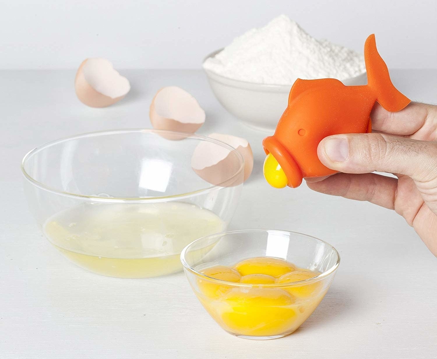 Fish shaped suction tool holding a yolk 
