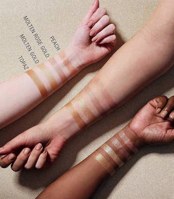 Three arms in different skin tones with swatches of the Maybelline Master Chrome Metallic Highlighter powder