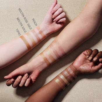 Three arms in different skin tones with swatches of the Maybelline Master Chrome Metallic Highlighter powder