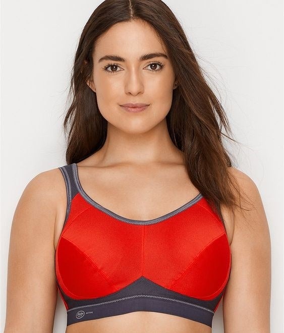 model wearing the red and grey sports bra