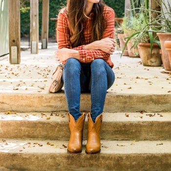 a model in brown short cowgirl boots