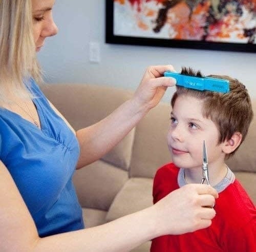 person cutting hair using the clips