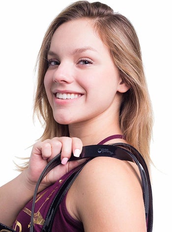 Model wearing purse with silicone strip on the strap