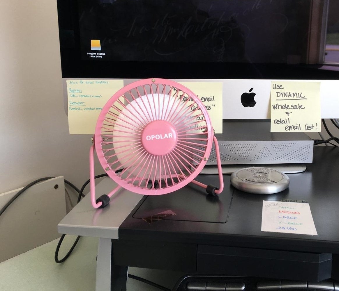 Reviewer photo of pink mini fan placed on desk