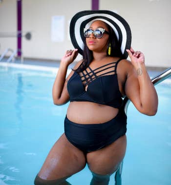 reviewer wearing swimsuit in black