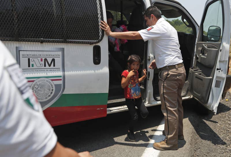 A Central American migrant child cries as she is asked to get into an immigration vehicle as she is detained on the highway to Pijijiapan, Mexico.