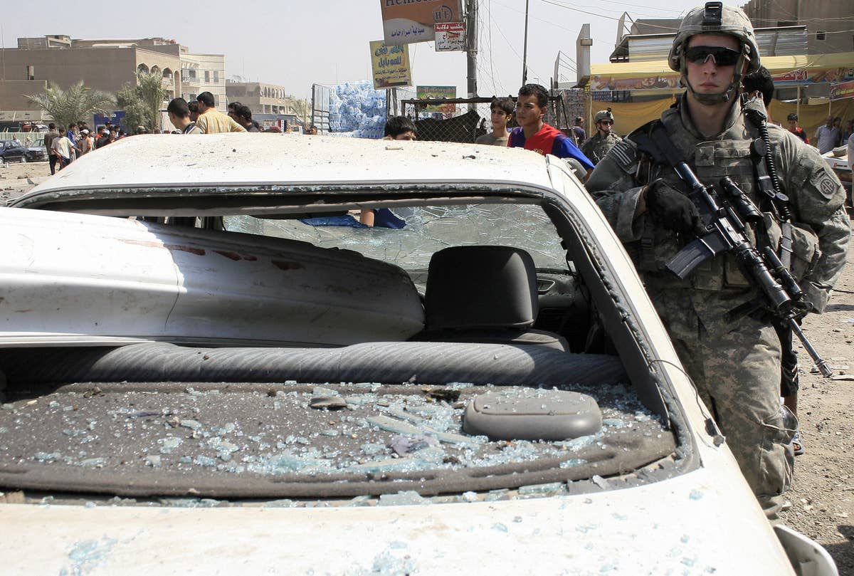 A US soldier stands guard at the site of a car-bomb attack in Baghdad on Sept. 17, 2007.