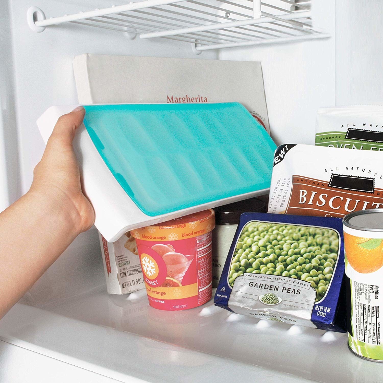 full freezer with ice cube tray covered and being placed on its side