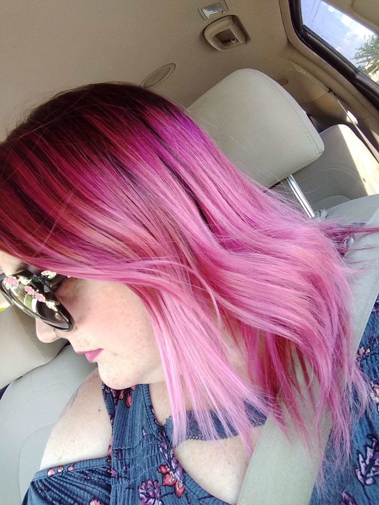 A reviewer's bleached and dyed pink hair looking shiny