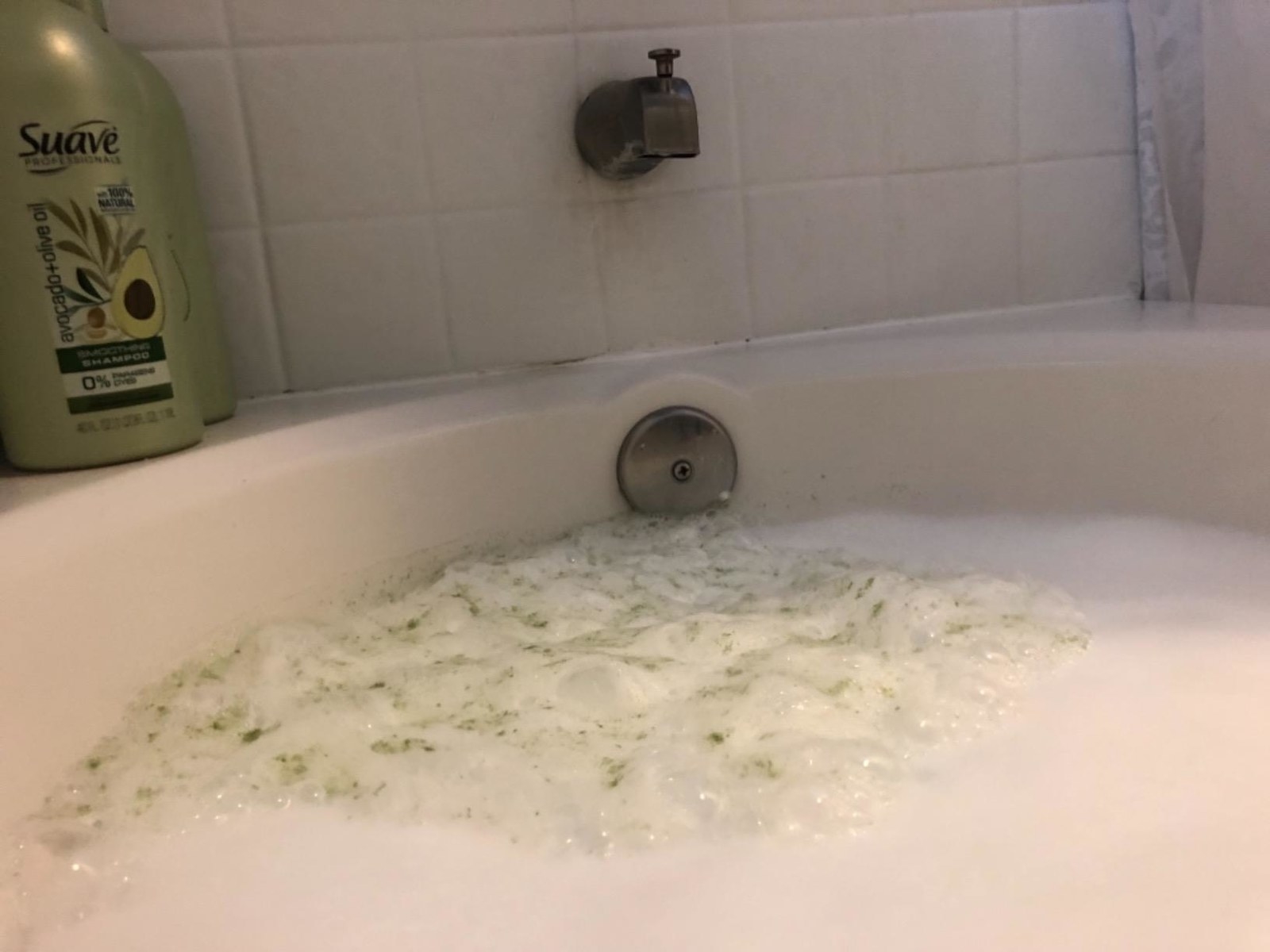 dirty green foam in tub