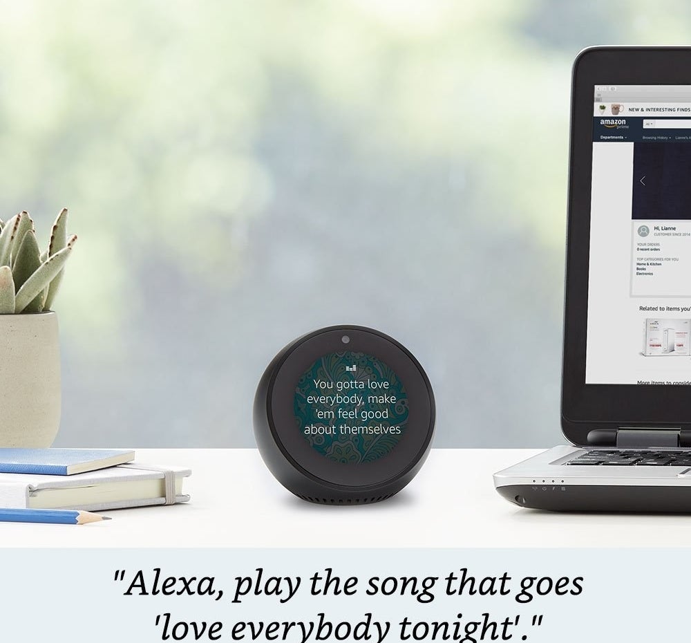The Echo Spot displaying song lyrics on its round screen. It is roughly the size of a magic 8 ball 