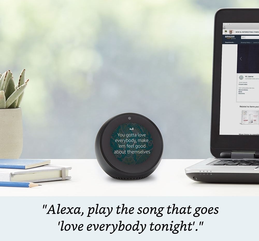 The Echo Spot displaying song lyrics on its round screen. It is roughly the size of a magic 8 ball 