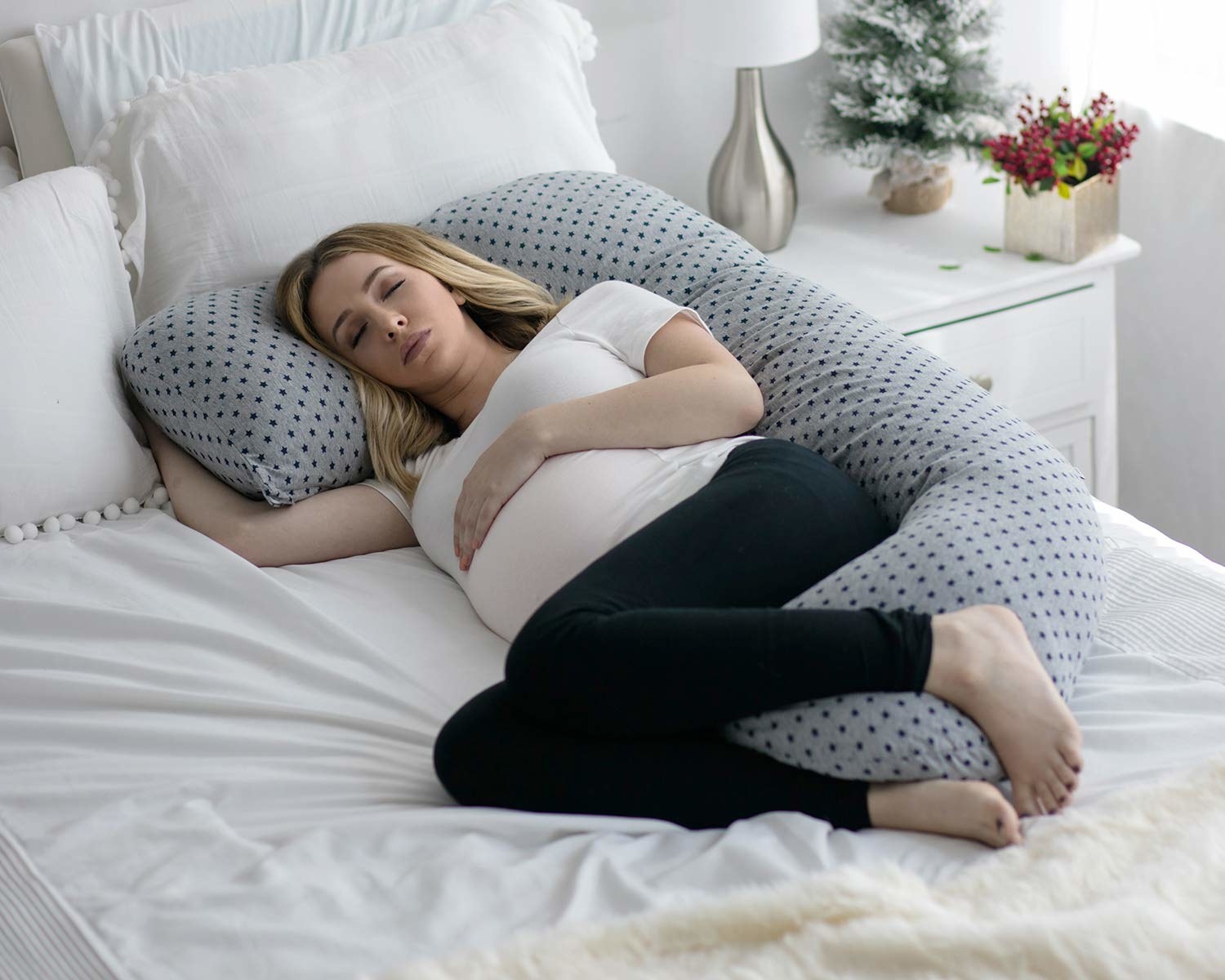 pregnant person sleeping with the pillow
