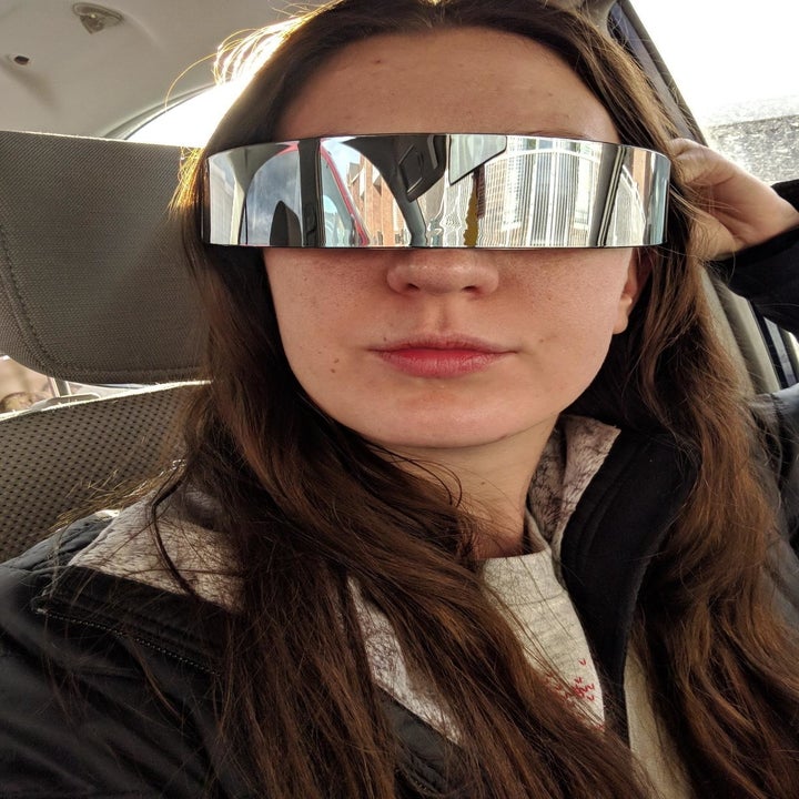 A person wearing the seamless sunglasses, which are shaped like a headband