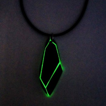 The necklace looks like a black piece of crystal with green glow-in-the-dark edges