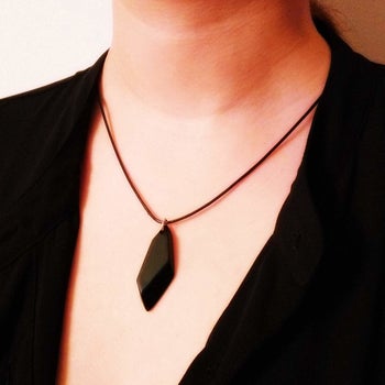 A person wearing the necklace 