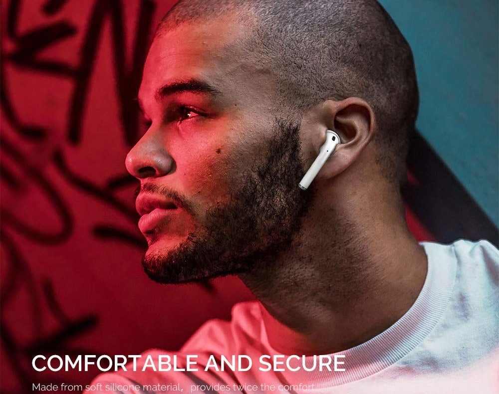 model wearing AirPods in their ears with the covers on them 