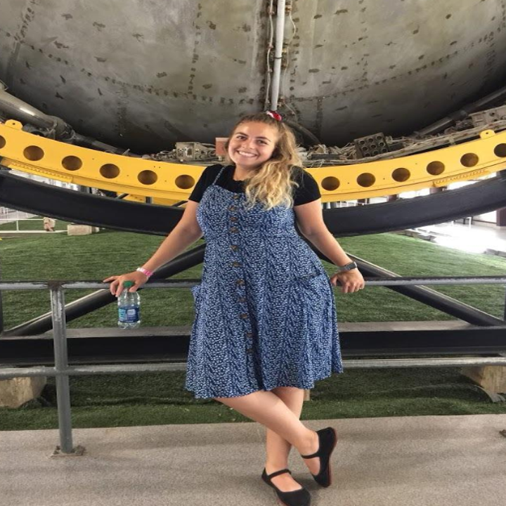 reviewer wearing the dress with pockets in blue floral over a tee