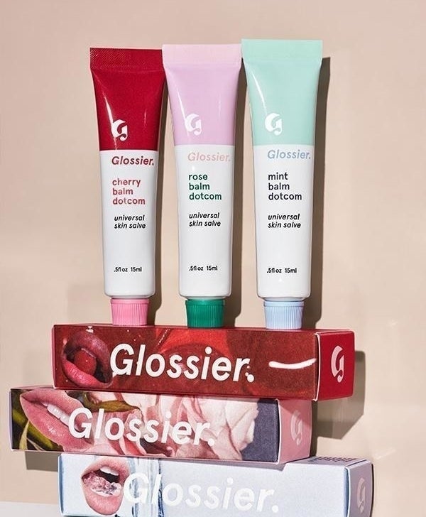 Three half-ounce tubes of the cherry, rose, and mint flavors of the product, which is called Glossier Balm Dotcom Universal Skin Salve