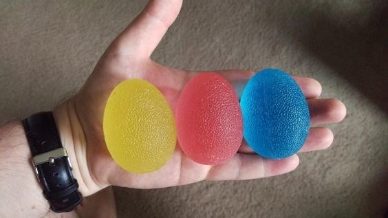 reviewer photo showing a yellow, red, and blue squishy egg 