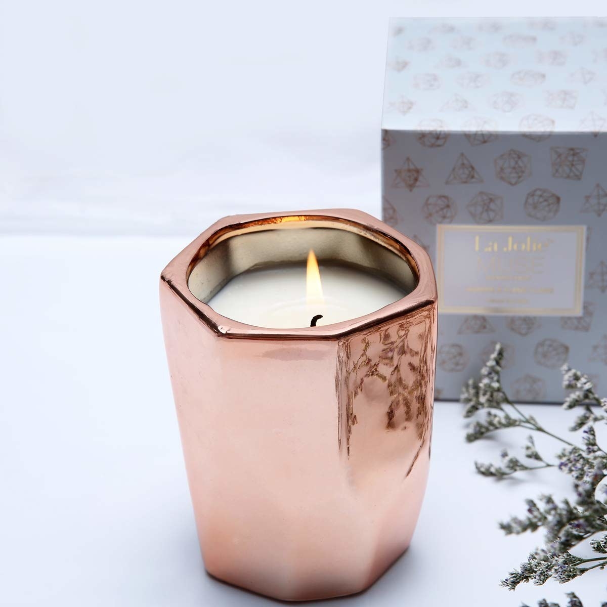 candle in rose gold color jar