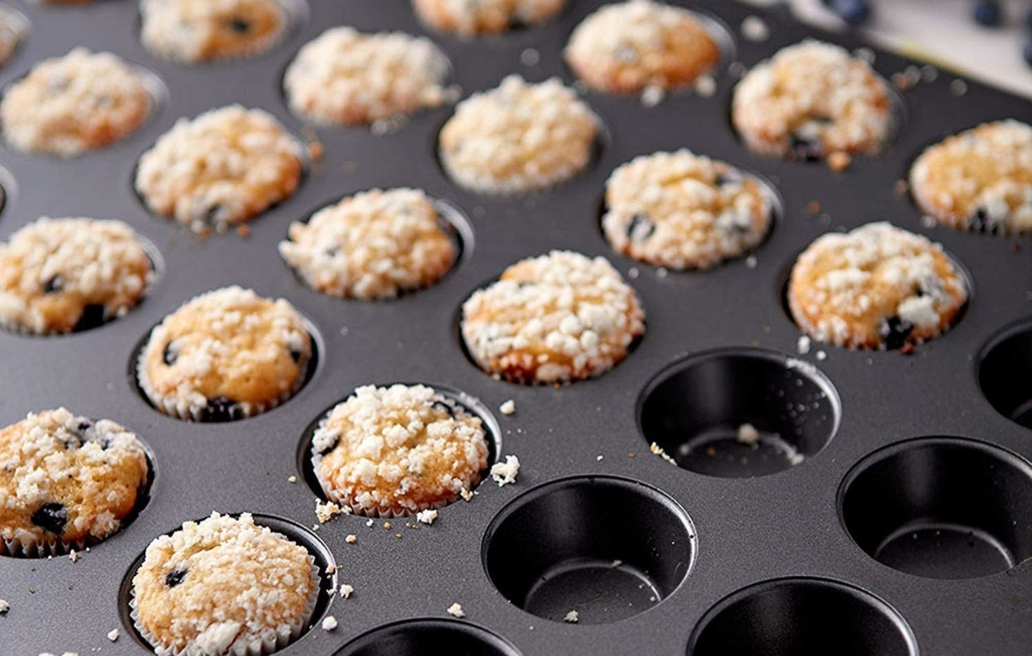 The mini muffin tin with baked muffins in it