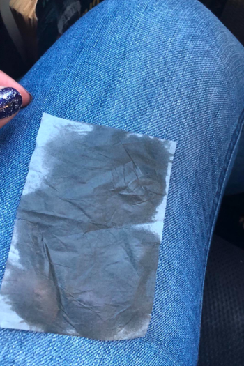 a small rectangular blotted paper greasy with oil