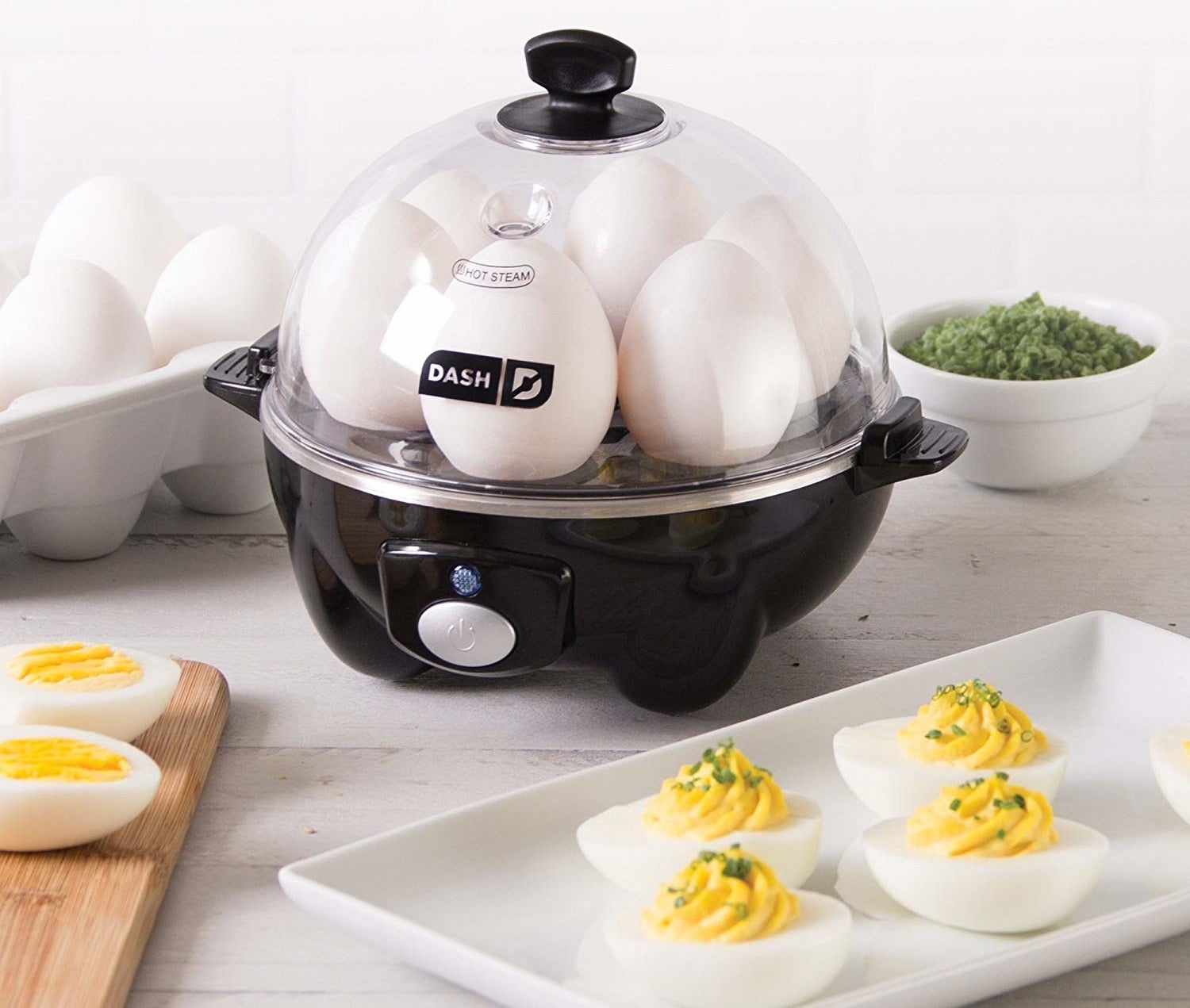 The black egg cooker with six eggs, plus a tray of deviled eggs