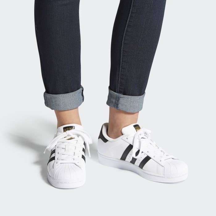 adidas superstar shoes with three black stripes on either side