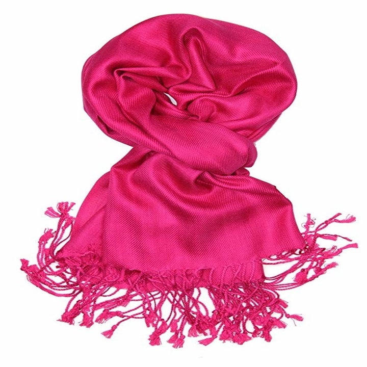 The scarf with fringe on the end in bright pink