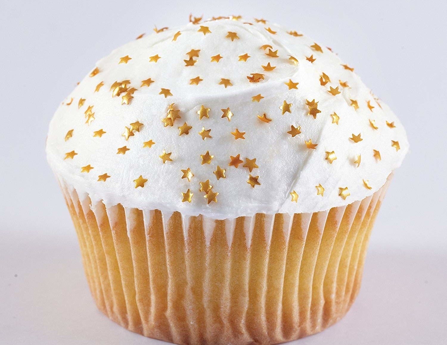 The edible gold stars on top of a cupcake