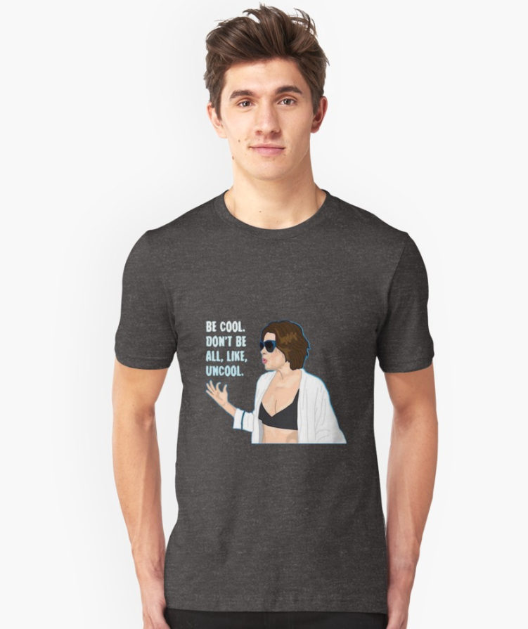 a model wearing a shirt with an illustration of luann on it and &quot;be cool. don&#x27;t be all, like, uncool&quot; on it