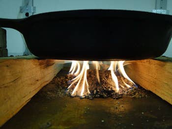 cast iron pan over an outdoor fire