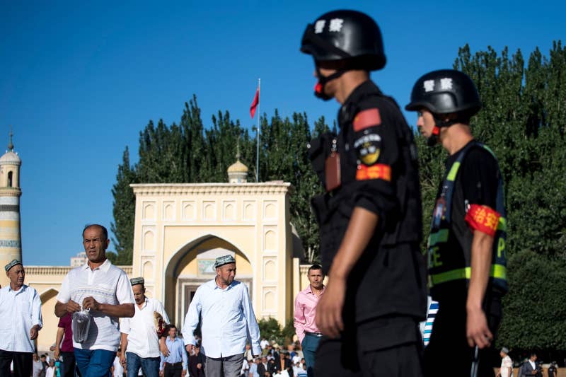 Police patrol a mosque in Kashgar, July 2017.