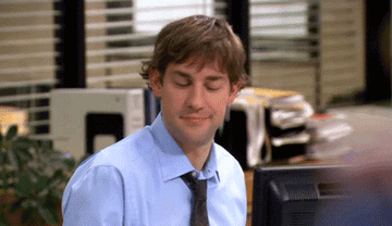 Jim and Pam at their desks in NBC&#x27;s The Office, air-high fiving about 10 feet away form each other