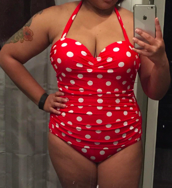 a reviewer in the bathing suit in red with white polka dots