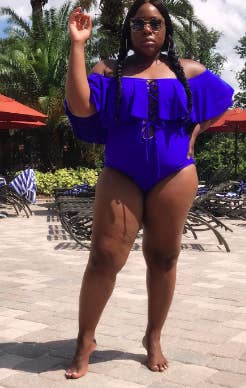 a reviewer in the off the shoulder one piece in blue