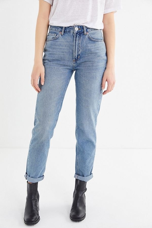 A model wearing the jeans with the hem folded 