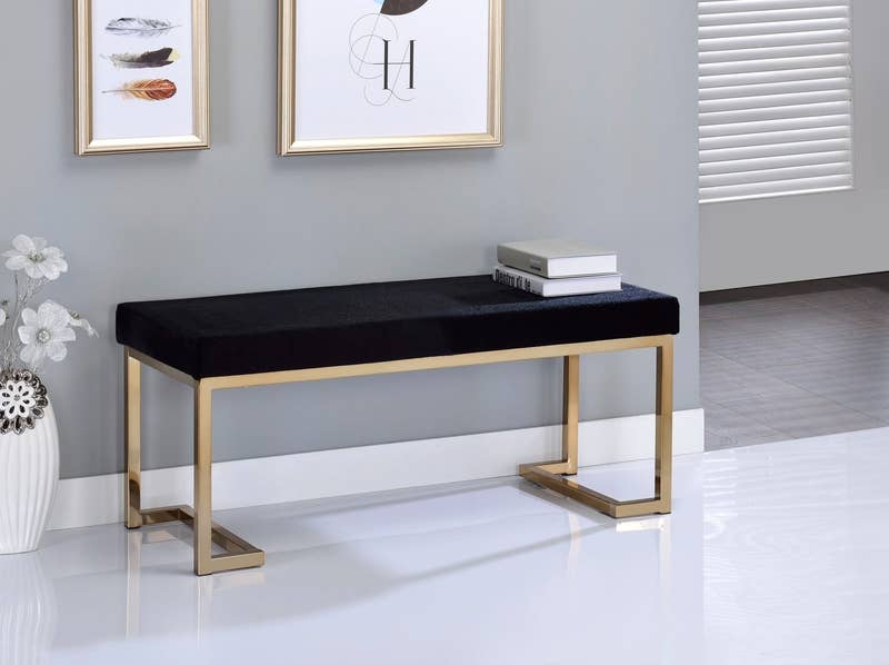 Promising review: "Do you ever purchase a furniture piece online then when you receive it you are so disappointed because it is flimsy and looks cheap? Well this is NOT the feeling here. This bench is sturdy, the color of the black seat is elegant, the champagne legs do the trick. Assembly straightforward. Love this bench." —MariaPrice: 9.41