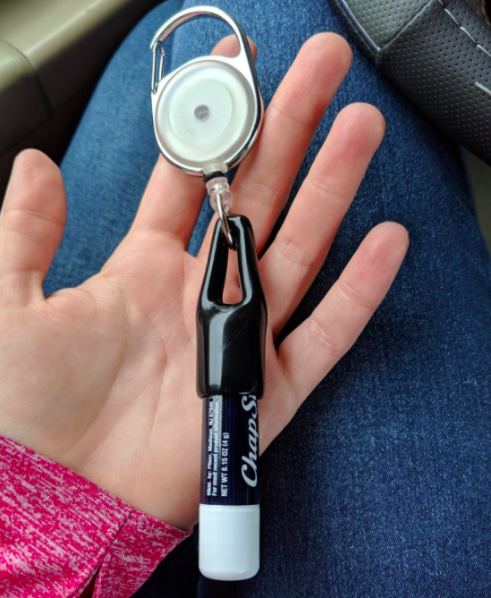 A customer review photo of the lip balm keychain holding their Chapstick