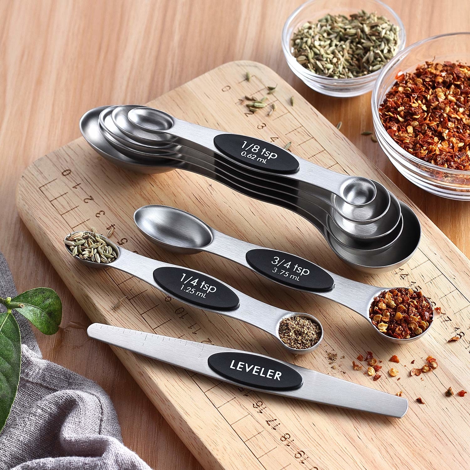 The magnetic measuring spoons laid out on a cutting board. 