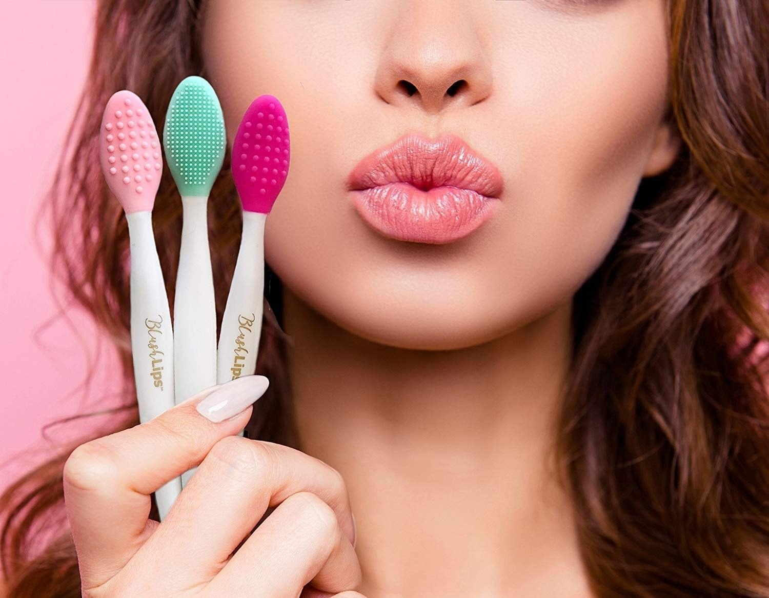 A model holding three scrubber lip brushes. 