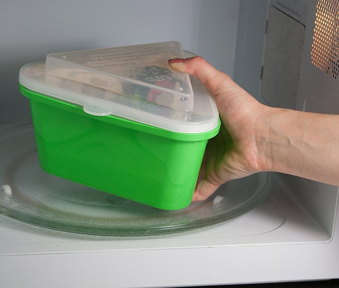 The veggie steamer being placed in a microwave